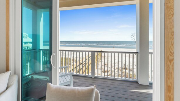A balcony with a view of the beach.