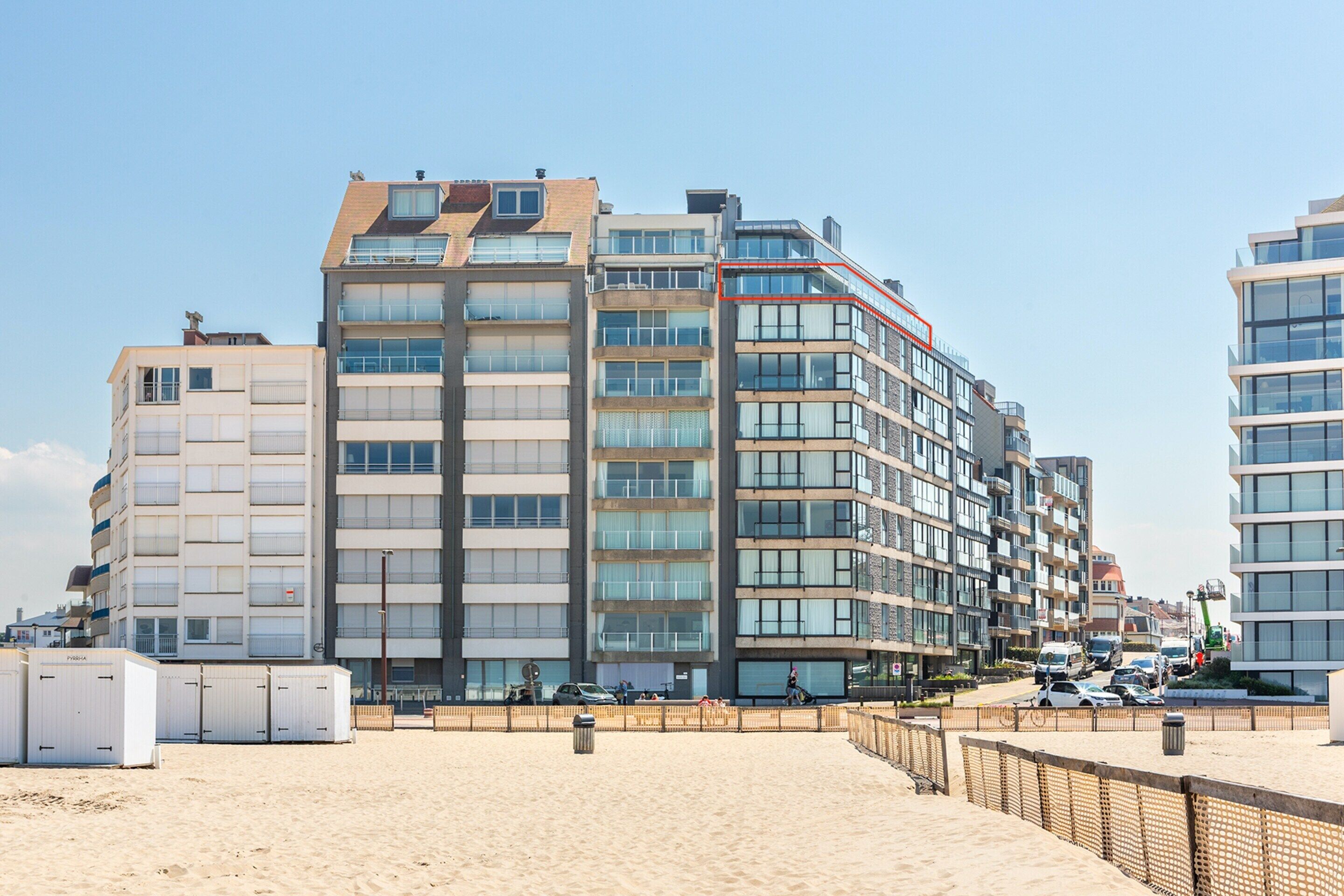 A multi-story hotel with a modern architectural design, featuring balconies and large windows.