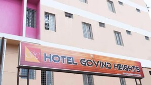 A multi-story building with a sign for Hotel Govind Heights. - Hotel Govind Heights (Tirupati)