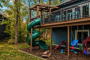 A playground with a slide, swings, and a climbing structure. - Spacious 5-bedroom A-Frame in South Haven with view of Lake Michigan (South Haven)