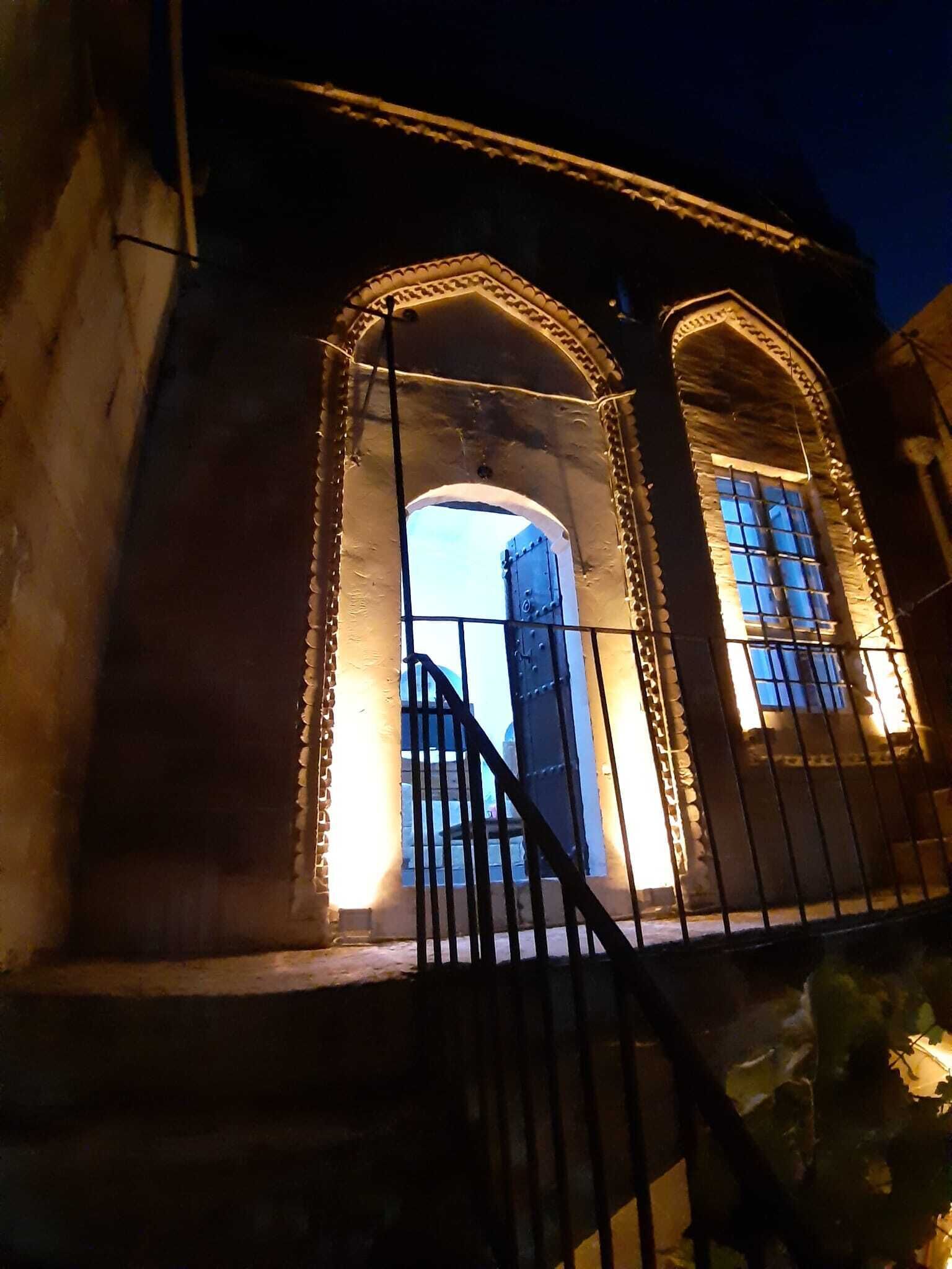 A building with arched windows and a metal gate.