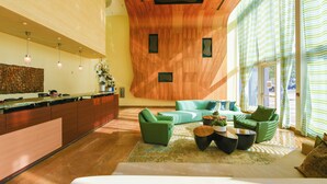 A modern hotel lobby with a wooden ceiling, green sofas, a reception desk, and large windows. - Ocean View Luxury Studio @ Brickell-DWTN Miami (Miami)