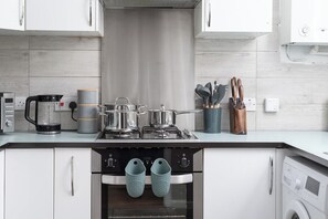 Enjoy cooking in this well-equipped kitchen with a central island, stove, and oven, along with a coffee maker and kettle.