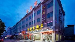 A hotel with multiple floors, a prominent sign with Chinese characters, and a well-lit facade. - Guangzhou Jintai Hotel (Jianggao Store) (Guangzhou)