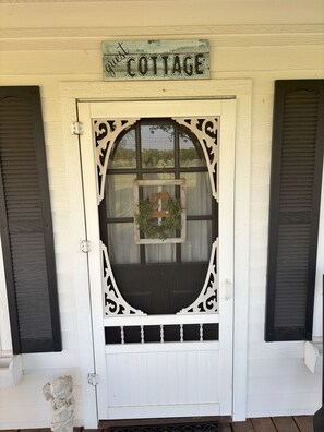 Guest Cottage entrance with a charming wreath and a welcoming statue.