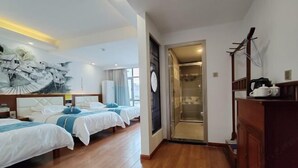 A hotel room with three beds, a wooden floor, a painting on the wall, a clock, and a coffee machine. - Mengxiyuan Resort Hotel (Zhangjiajie)
