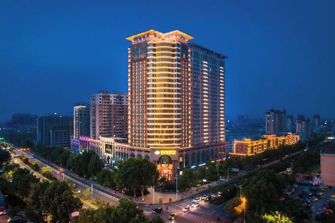 A high-rise hotel with multiple floors, a prominent entrance, and a surrounding urban environment.