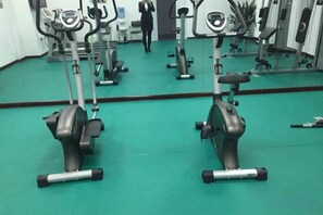 A gym with stationary bikes and exercise equipment.