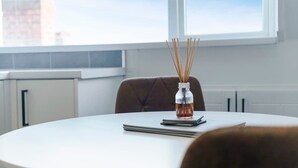 A round table with a bottle of rose water and reed sticks, a notebook, and a pen. - Central Darlington Sleeps 8 with WiFi and Parking (Darlington)