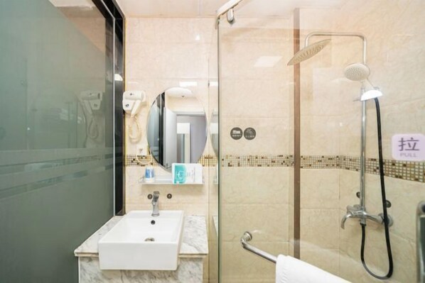 A modern bathroom with a glass shower enclosure, a sink, and a mirror. - Jiting E-sports Hotel (Wujiaochang Shanghai Sports University Branch) (Shanghai)
