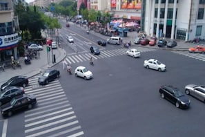 A busy urban intersection with multiple lanes and vehicles. - Colorful Art Hotel Shanghai (Shanghai)