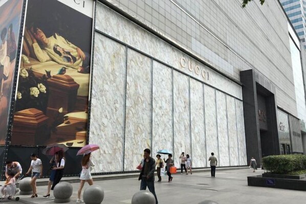 A modern building with a large 'GUCCI' sign on the facade. - Ramada Plaza by Wyndham Tian Lu Hotel Wuhan (Wuhan)
