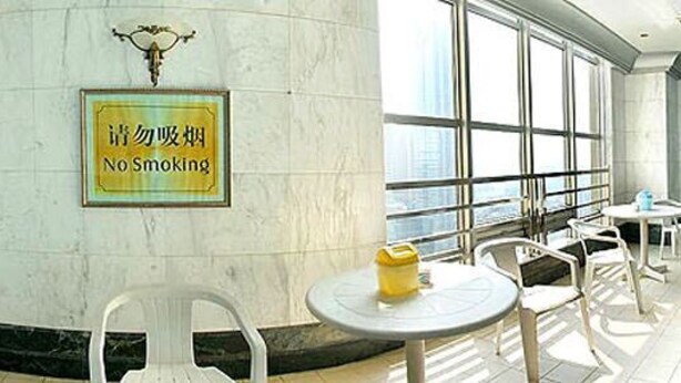 A large indoor swimming pool with clear blue water, surrounded by lounge chairs and a 'No Smoking' sign. - Ramada Plaza by Wyndham Tian Lu Hotel Wuhan (Wuhan)