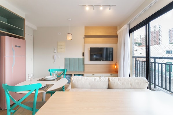 Enjoy a city view from the large window, relax on the sofa, and dine at the table with comfortable seating.