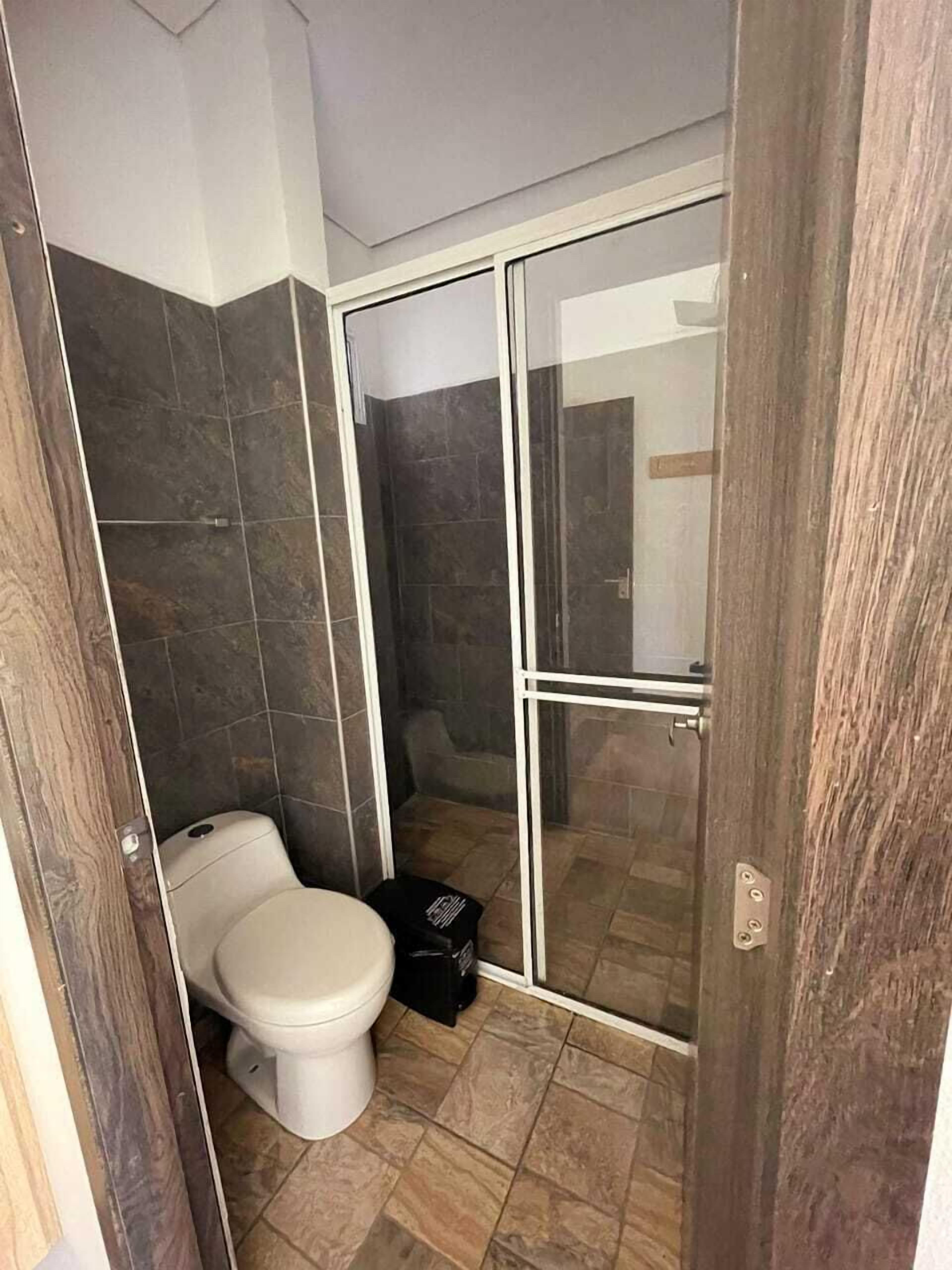 Separate bathtub and shower, towels, soap, toilet paper