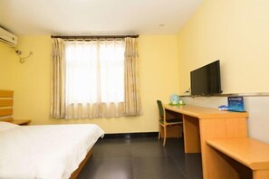 A hotel room with a bed, desk, chair, television, and a window with curtains. - Tianci Liangyuan Hotel (Beijing Tongzhou Fuheyuan) (Beijing)