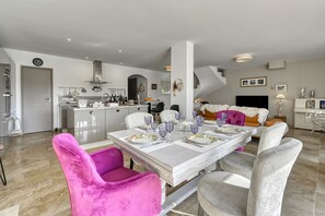 Enjoy meals with family and friends at the dining table, set for four, in this stylish living space.