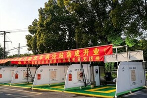 A row of fuel pumps with a red banner overhead. - Kaimanguoji Hotel (Shanghai Dongjing Branch) (Shanghai)