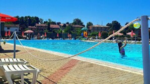 A swimming pool with lounge chairs and umbrellas. - PetFriendly Holiday Home Among the Vineyards (Bosnasco)