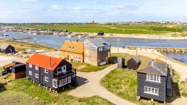 A coastal village with houses near the water, a dock, and a bridge. - Ocean View, Walberswick (Walberswick)