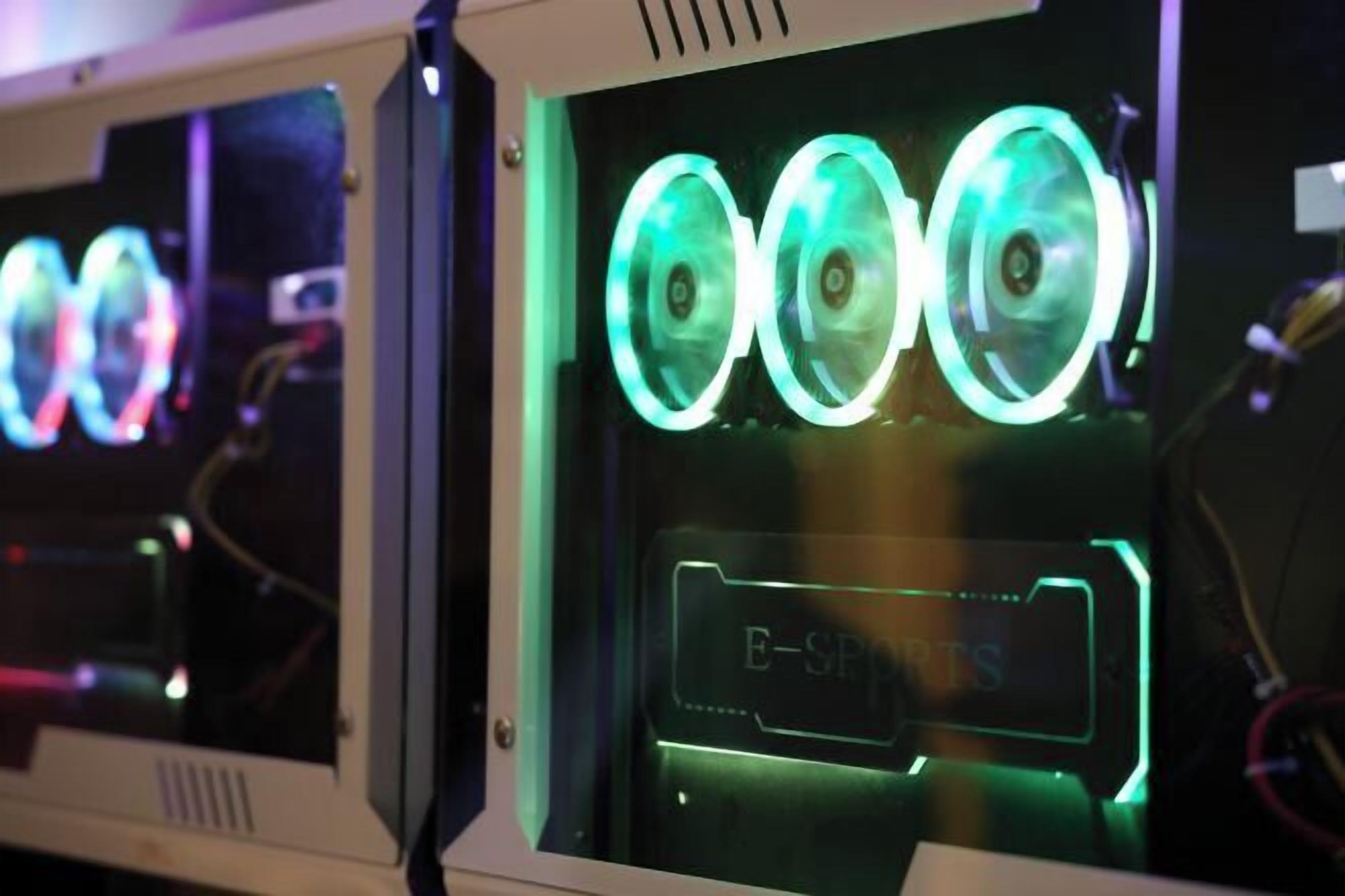 A computer case with illuminated cooling fans and a label reading "E-SPRETS".