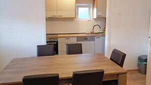 A compact kitchen with a dining area. - Sunny Trogir Apartment With 3 Bedrooms (Trogir)
