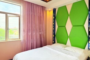 A bedroom with a bed, a window, and a wall with a geometric design.