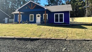 A two-story house with a gabled roof, a front porch, and a fenced yard. - Rayburn Blue•Close to Ramp•New Home•Large Driveway for Multiple Trucks and Boats (Zavalla)
