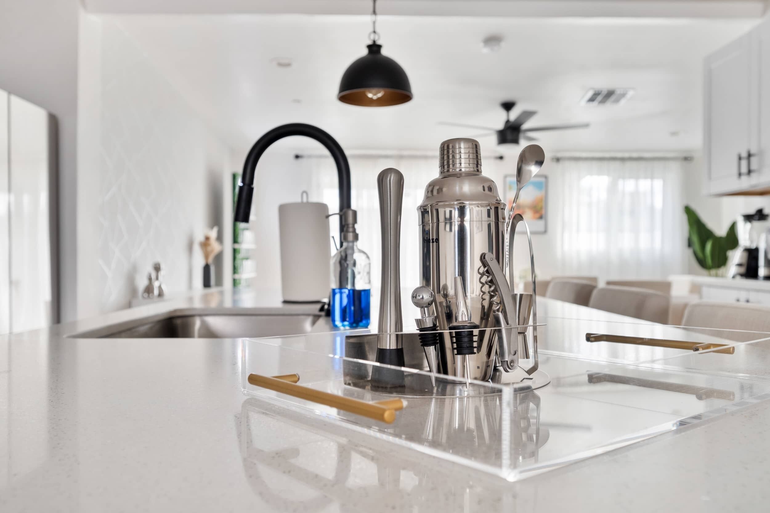 A modern kitchen with a central island, stainless steel appliances, and a clear countertop.