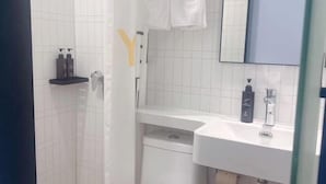 A bathroom with a white tiled wall, a white sink, a mirror, and a towel hanging on the wall. - 100 Inn Hotel (Shanghai Zhenping Road Subway Station) (Shanghai)