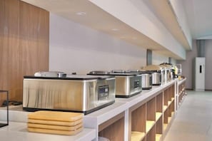 A buffet setup with multiple self-service stations. - Celebrity Youngsun Xinhua Hotel (Mianyang)
