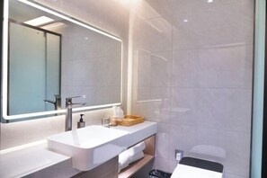 A modern bathroom with a large mirror, a white sink, and a wooden tray. - Celebrity Youngsun Xinhua Hotel (Mianyang)