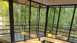A modern interior with large windows, wooden flooring, and hanging pendant lights. - Beautiful House With Views To The Reservoir And Wonderful Waterfalls. (El Peñol)