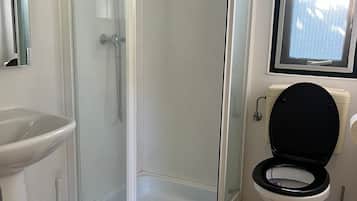 Shower, hair dryer, towels, toilet paper