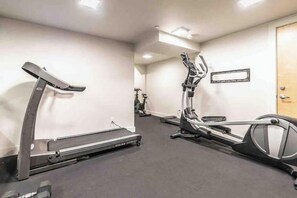 A gym with treadmills and elliptical machines.