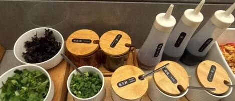 A food preparation area with various ingredients and containers.