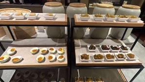 A buffet with various food items including eggs, pastries, and other dishes arranged on tables. - Yandang Hotel (Wenzhou Teacher Education Institute Yandang) (Yueqing)