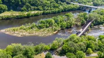 A river with a bridge and surrounding greenery.