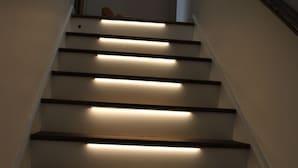 A staircase with wooden steps and built-in lighting.
