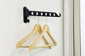 A wall-mounted wooden hanger rack with two hangers. - Hotel Apartment (Shanghai National Convention and Exhibition Center Jiangqiao Old Street Branch) (Shanghai)