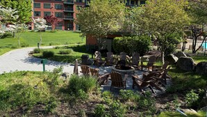 A courtyard with outdoor seating, a fire pit, and a view of multi-story buildings. - Condo at Mtn Creek  sleep 4 Mountain view 1 Bdr 1 Bath #234 (Vernon Township)