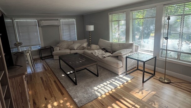 A modern living room with a sofa, coffee table, and floor lamp. - Luxury West 7th Fort Worth Stay - Balcony • W/D (Fort Worth)