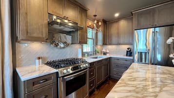 Enjoy cooking in this well-equipped kitchen with an oven, island, and stainless steel appliances.
