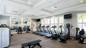A gym with treadmills, elliptical machines, and weight equipment. - Spacious 5-bedroom townhome with WiFi, AC in delightful Davenport (Davenport)