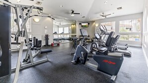 A gym with cardio equipment, weight machines, and a mirror wall. -  Best Scottsdale location. Shopping, Food, Golf, near (Scottsdale)
