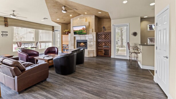 A spacious living room with a fireplace, leather sofas, and a television. -  Best Scottsdale location. Shopping, Food, Golf, near (Scottsdale)