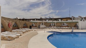 A swimming pool with lounge chairs and a stone pathway. - RentitSpain · Little Paradise on the Costa del Sol (Torremolinos)