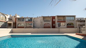 A residential building with a swimming pool, balconies, and a clear sky. - Apartment located 100 m from the beach, with a pool and parking (Agde)