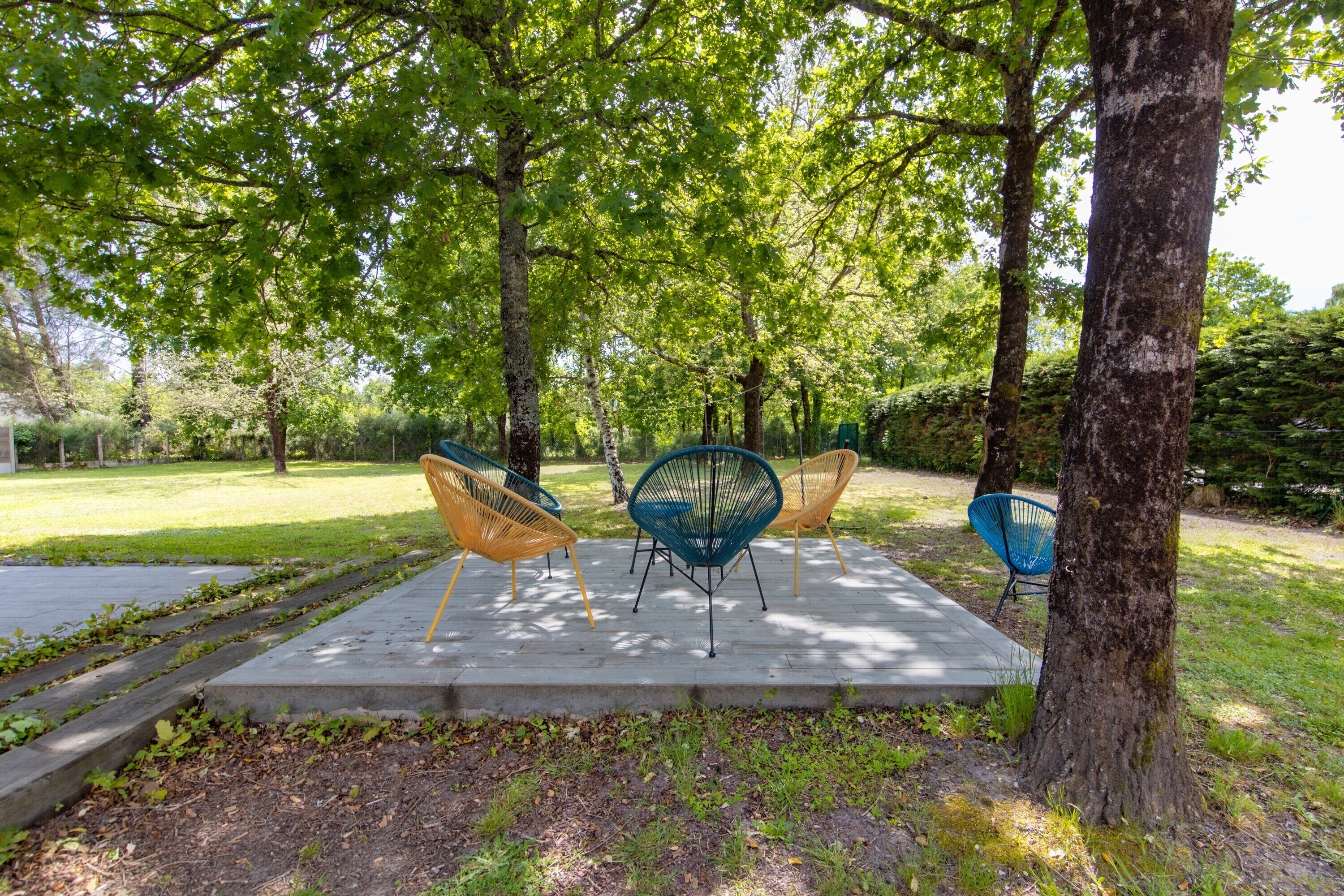 A park with outdoor seating and trees.