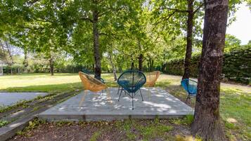 A park with outdoor seating and trees.